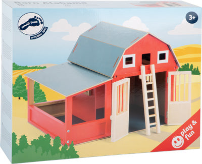Spielzeug-Holzscheune, inspiriert von US-amerikanischen Pferdestallungen, mit blauem Dach, weißen Türen und Leiter. Wird in farbenfroher Verpackung geliefert und ist für Kinder ab 3 Jahren geeignet.