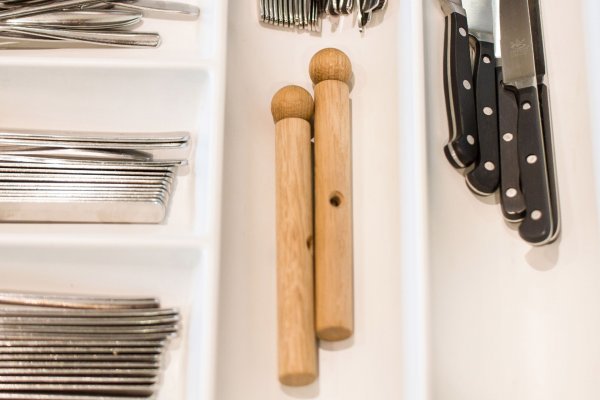 Zwei Holzpfeifen in einer Besteckschublade mit Gabeln und Messern in der Nähe, entworfen von Anton Preis, verleihen Ihrer Küche einen Hauch von Charme.