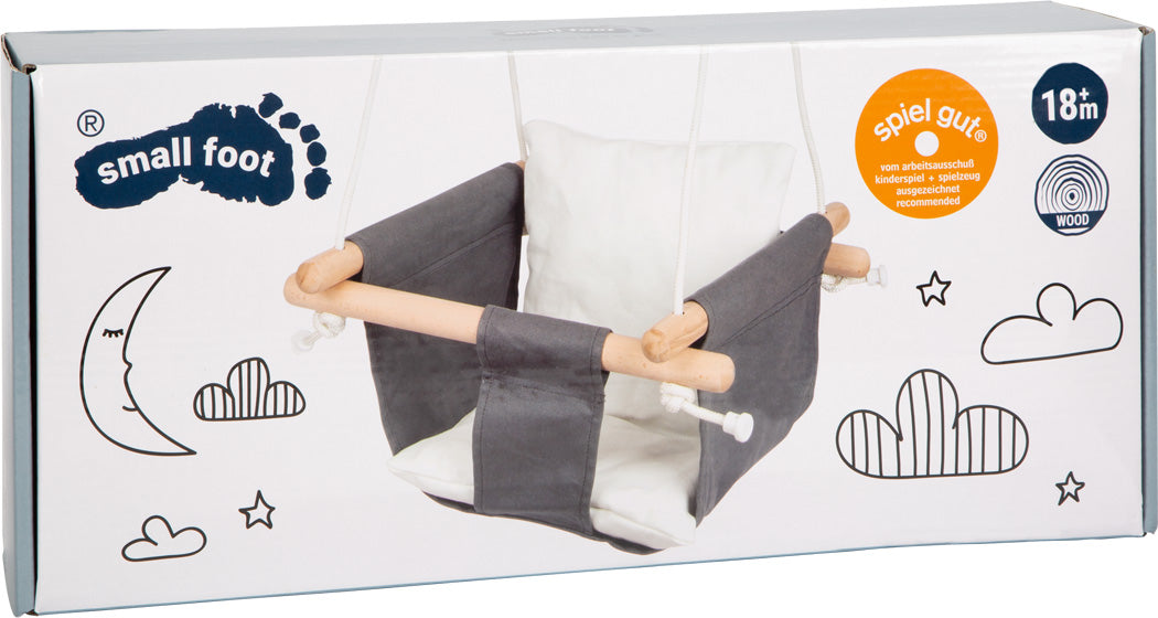 Graue und weiße Babyschaukel Indoor aus Holz in Box mit Mond- und Wolkenmotiven.
