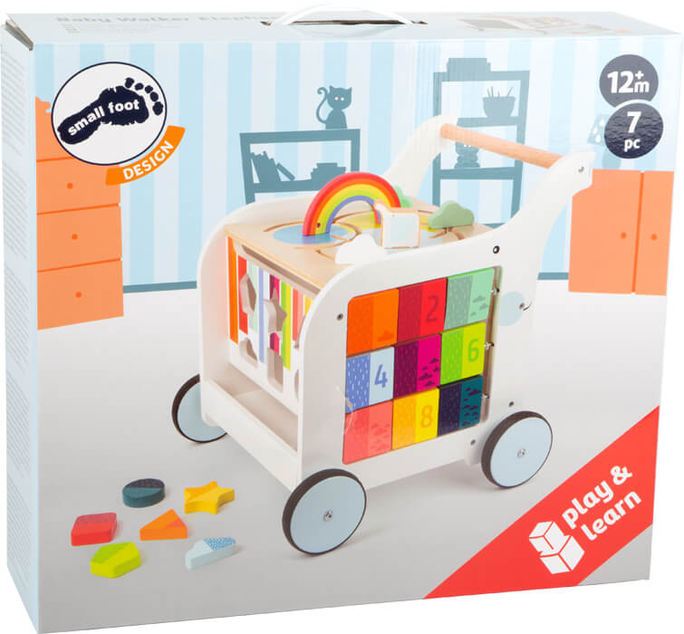 Die Schachtel zeigt einen farbenfrohen Baby-Lauflernwagen aus Holz mit Bauklötzen, Formen, Tafelfläche und einem Regenbogen, der als Lauflern-Elefant für Kinder ab 12 Monaten konzipiert ist und die motorische Entwicklung unterstützen soll.