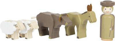 Holzspielzeugfiguren eines Hirten, zweier Schafe, einer Kuh und eines Esels stehen in einer Reihe – ein bezauberndes Holzspielzeug, das sich perfekt als Teil Ihrer Weihnachtsdekoration eignet.