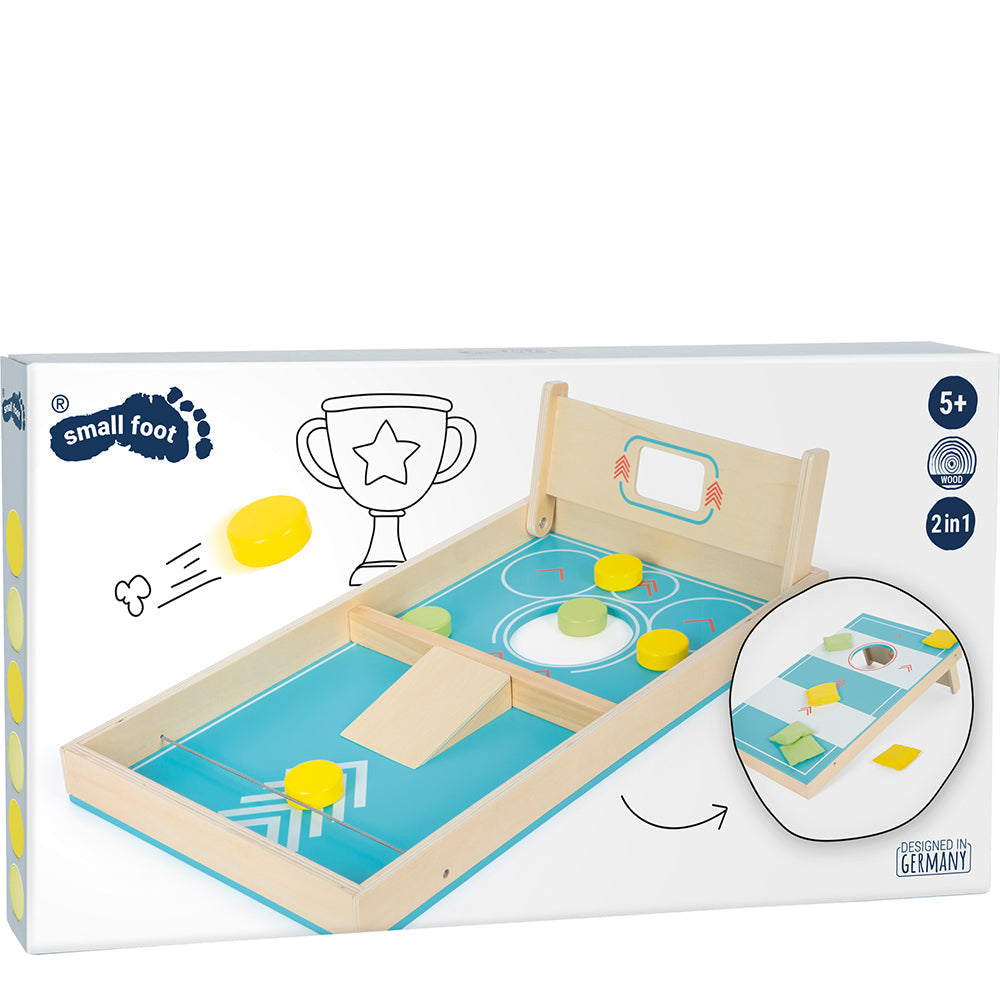 Schachtel mit einem hölzernen Sling-Puck-Tischspiel für Kinder mit gelben Scheiben und einem kleinen Tor, gekennzeichnet für Kinder ab 5 Jahren.