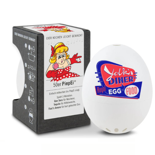 Der weiße, eiförmige Küchentimer, inspiriert von PiepEi, befindet sich neben seiner Verpackung mit einem Cartoon-Koch und Kochanweisungen – ideal für perfekt gekochte Eier mit Melodien, die signalisieren, wann Ihre Eier fertig sind.
