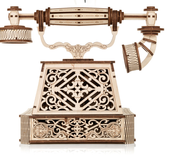 Ein dekoratives Modell eines antiken Telefons aus Holz mit detaillierten  geschnitzten Mustern und filigranen Verzierungen auf dem Gehäuse.
