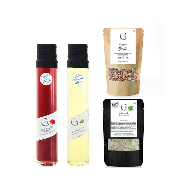 Zwei schmale Flaschen mit rotem und gelbem Inhalt stehen neben zwei Tüten  die mit getrockneten Blüten und Kräutersalz gefüllt sind.
