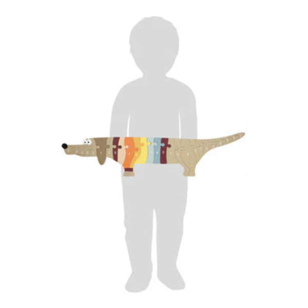 Eine Kindersilhouette steht hinter einem bunten ABC-Puzzle-Hund-Holzpuzzle, das bis zur Mitte des Rumpfes reicht.