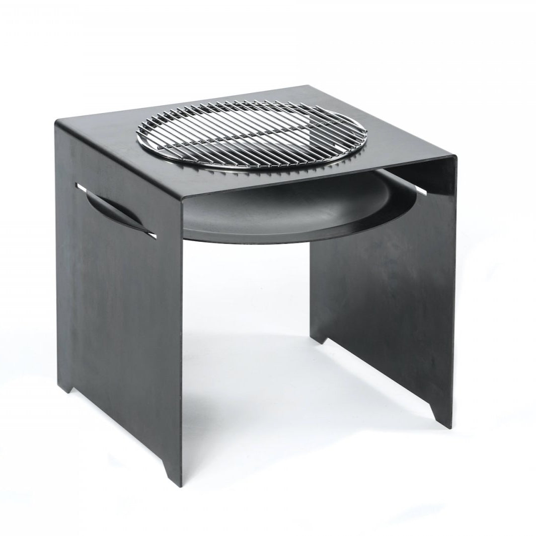Quadratischer schwarzer Metallgrill mit rundem Edelstahl-Grillrost oben und Griffen an beiden Seiten, Teil der Feuerschale BASIC-Serie, vor weißem Hintergrund.