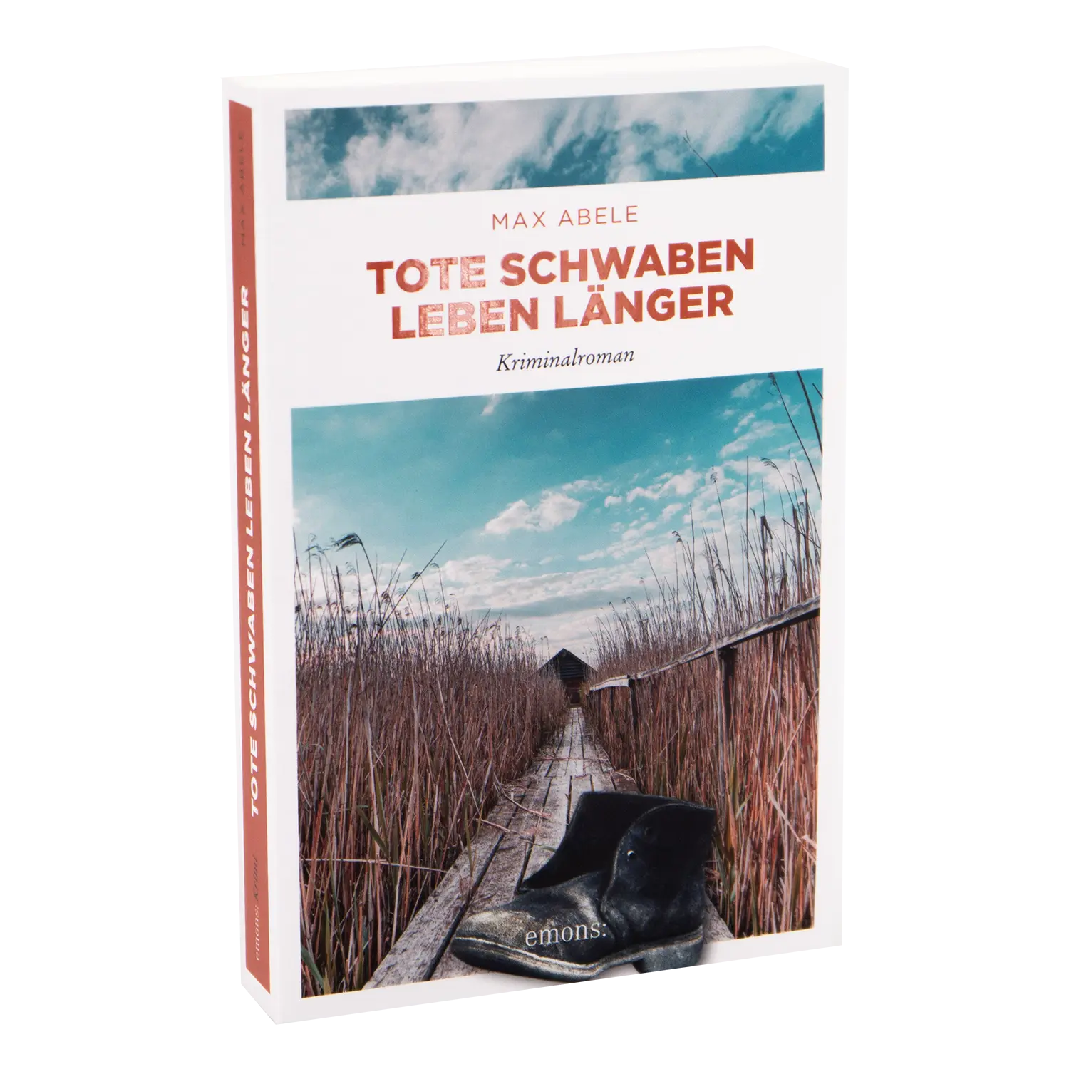 Das Bild zeigt das Buch „Tote Schwaben leben länger“ von Max Abele, das schwäbischen Humor und Krimi vereint. Das Cover zeigt einen Holzweg durch Schilf mit schwarzen Stiefeln unter einem bewölkten Himmel.