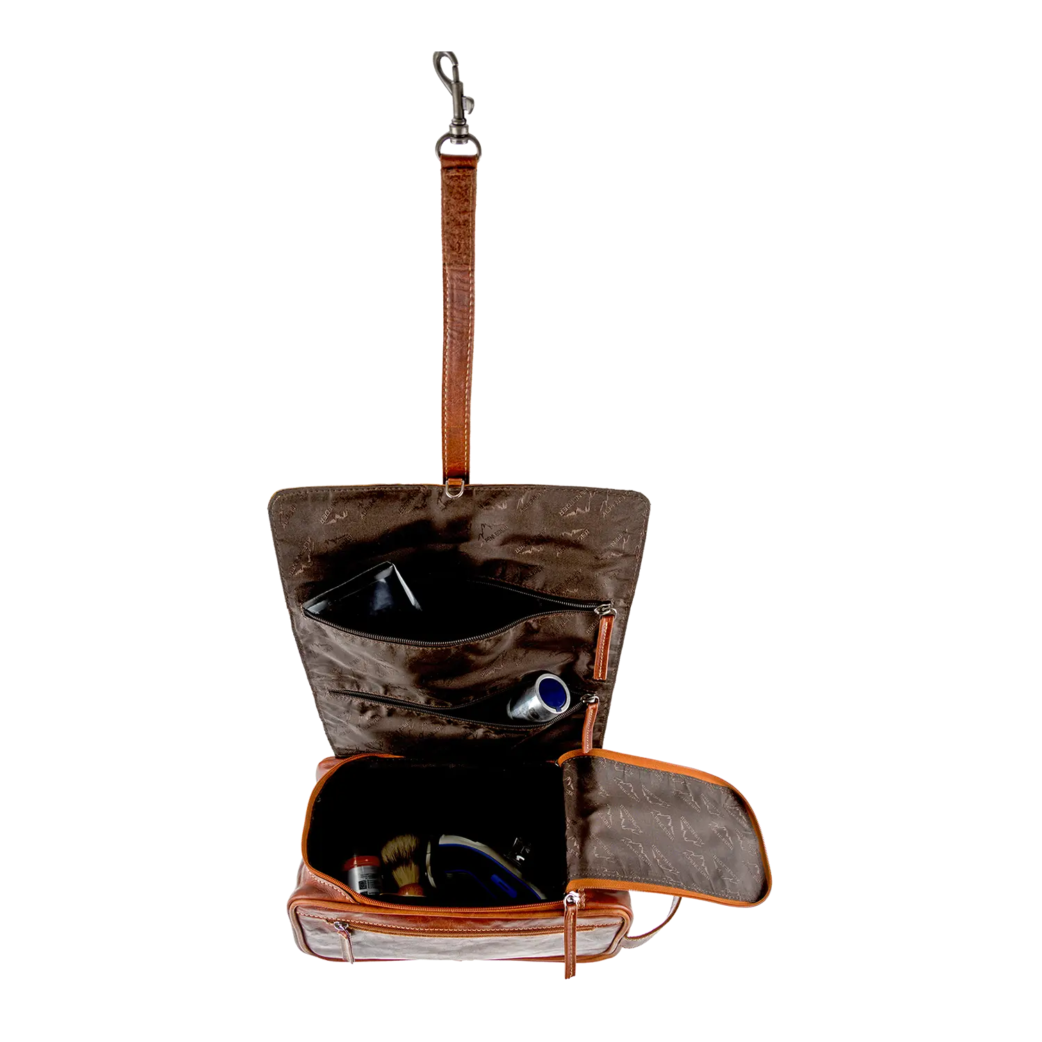 Die Kulturtasche für Damen und Herren ist eine wasserfeste Vollledertasche mit brauner Außenseite und beiger Innenseite. Sie verfügt über mehrere Fächer für Gegenstände wie Zahnbürste, Tube und kleine Bürste und hat einen Haken zum Aufhängen.