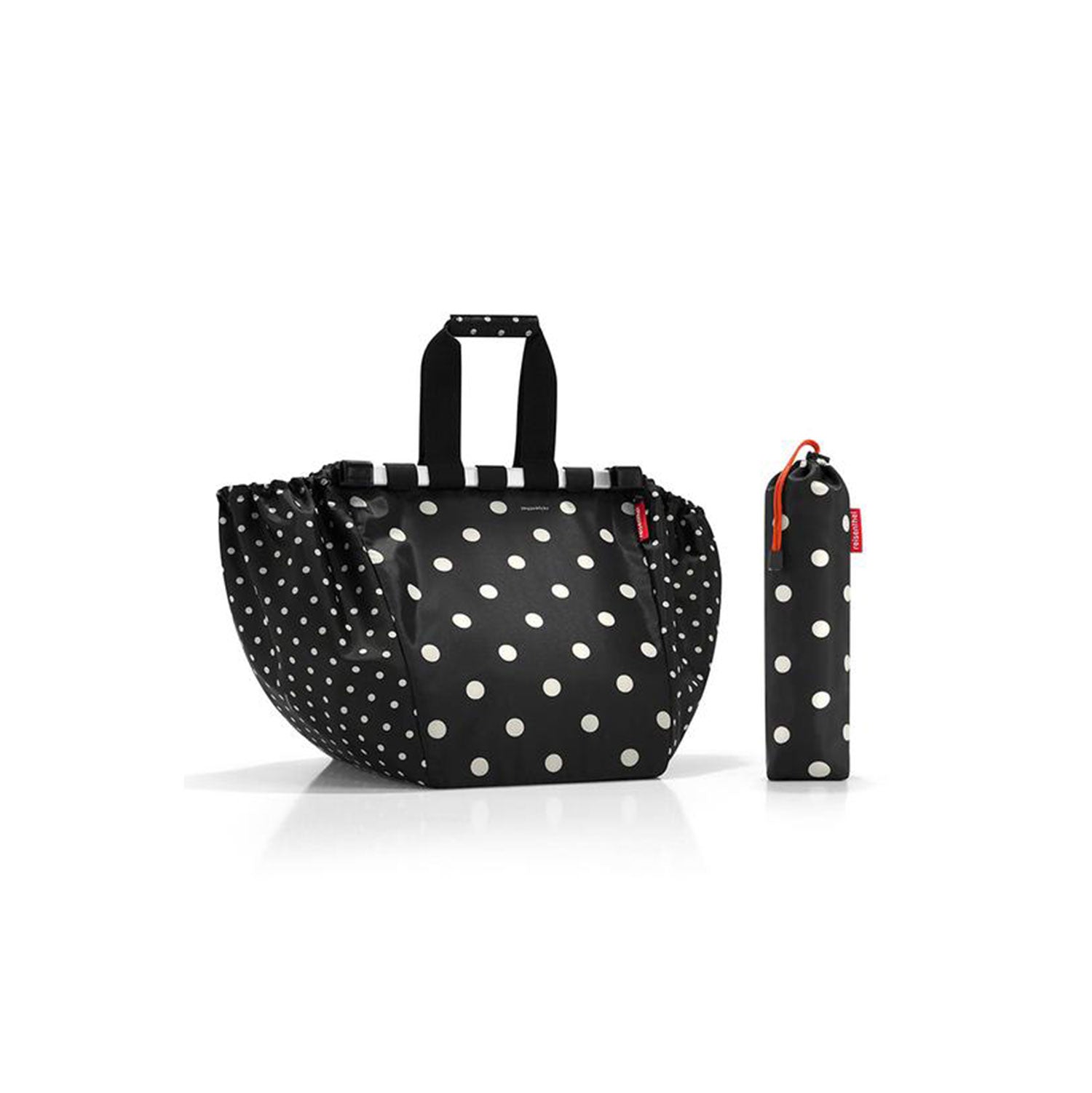 Die Reisenthel Easyshoppingbag dots mit schwarz-weißen Punkten und zwei kurzen Henkeln sowie einem passenden zylindrischen Beutel auf weißem Grund bieten eine umweltfreundliche Option für einen nachhaltigen Lebensstil.