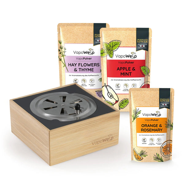 Ein VapoWesp-Set mit einer Räucherbox aus Holz und drei aromatisierten Kräuter-Nachfüllpackungen.